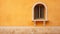 Spanish Palladian Architecture: A Stunning Arched Window On An Orange Wall