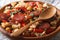 Spanish rustic migas with chorizo and vegetables close-up. Horiz