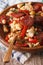 Spanish rustic migas with chorizo and vegetables close-up. Verti