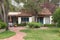 Spanish style adobe cottage nestled in tall trees, Monterey, CA.