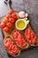 Spanish style toast with tomato Pan con tomate closeup on the wooden board. Vertical top view