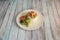 Spanish tapa of Russian salad with potatoes and boiled egg, canned tuna and pitted green olives, country peaks and a small salad