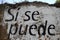 Spanish text painted on a wall: si se puede