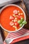 Spanish Tomato Strawberry Gazpacho cold soup on a wooden board close-up on the table. Vertical top view