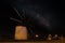 A Spanish windmill at night with the Milky Way galaxy in the sky.