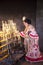 Spanish woman light up candles in a church