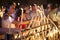 Spanish woman light up candles in a church