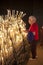 Spanish woman light up candles in a church