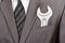 Spanner in businessman suit pocket