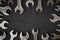 Spanners. Many wrenches. Black background. Set of wrenches in different sizes on black background.Close up. Blurred background