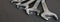 Spanners. Many wrenches. Grey background. Set of wrenches in different sizes on grey background.Close up. Blurred background