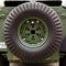Spare wheel close-up mounted on the body of combat car. Military industry concept