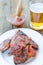 Spareribs on grill with hot marinade, czech beer