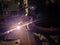 Spark light from asian technician man manual laser welding at su