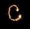 Sparklers forming letter C on dark background