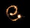Sparklers forming letter E on dark background