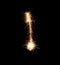 Sparklers forming letter I on dark background