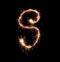 Sparklers forming letter S on dark background