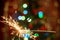 Sparklers near the Christmas tree with a red background
