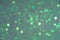 Sparkles defocus light. Glitter paper defocus as background. Green background with defocus