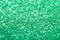 Sparkling abstract rich green background. Bright gradient glitter with blur effect. Holiday abstraction