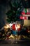 Sparkling bengal lights, Christmas tree, decorations, gift boxes on a wooden rustic background