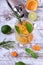 Sparkling beverage with slices of lime, kumquat and orange topped with mint