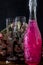 Sparkling brilliant raspberry drink. Champagne in two glasses stands on a wooden table with ice. For flowers and a garland