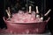 Sparkling champagne bottles chilling in a pink bucket filled with ice cubes, set against a dark backdrop with red berries.