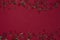 Sparkling colorful strass decoration on dark red background.