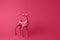 Sparkling deer decoration for Christmas. Deer figurine isolated on Viva Magenta color background. Christmas symbol