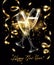 Sparkling glasses of champagne with Gold serpentine on black background, bokeh effect with sign Happy New Year