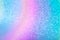 Sparkling glitter background with blur. Macro photo of shiny grainy paper with gradient blue and magenta coating