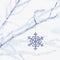 Sparkling glitter snowflake Christmas ornament decoration hanging from frosty branches with white snow background. Winter holiday