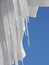 Sparkling icicles on the blue sky background