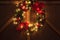 Sparkling Illuminated Christmas Garland Wreath at night of Christmas Eve. Christmas decoration with blinking warm golden