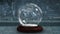 Sparkling light spirally moving around snow globe