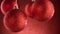 Sparkling Red Christmas Baubles on Red Blurred Background.