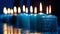 Sparkling row of diverse candles lighting up a blue setting Happy birthday card idea