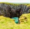 The sparkling sea viewed through the entrance to a Geo along the limestone cliffs of Stack Rocks on the Pembrokeshire coast, Wales