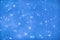 Sparkling stars blurred bokeh blue background, winter, christmas