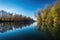 sparkling water, reflecting the sky and trees on a tranquil lake