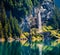 Sparkling waterfall on the Oeschinensee Lake. Splendid summer morning in the Swiss Alps, Kandersteg village location, Switzerland,