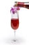 Sparkling wine during pouring from bottle to wineglass against orchid