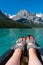 Sparkly sandals and women`s feet, relaxing on a canoe on Emerald Lake in Yoho National Park in Canada