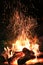 sparks over blazing campfire