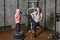 Sparring BOB or body opponent bag in gym, young woman practicing kicks.