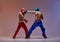 Sparring of fighting athletic males boxers wearing boxing gloves during battle, martial arts, mixed fight concept