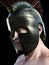 Spartan warrior wearing traditional helmet . Angled profile looking toward the camera on a black background. 3d render