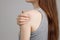 A spasm on the girl`s shoulder. Shoulder and joint injuries, and fatigue at work. The zone of injury, the image on a blank
